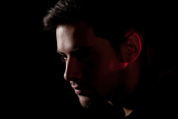 portrait of a young man on a black background