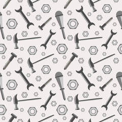 Seamless vector pattern with tools. Chaotic baackground with screws, nuts, hammers, wrenches and screwdrivers on the grey backdrop.