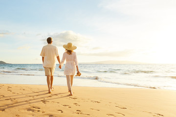 Mature Couple Walking on the Beach at Sunset - 98290639