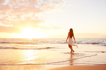 Fototapeta na wymiar Happy Carefree Woman on the Beach at Sunset