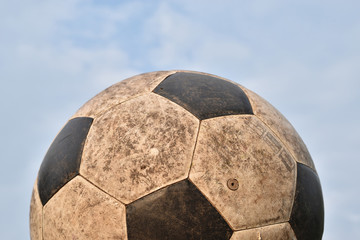 Old soccer ball on blue sky