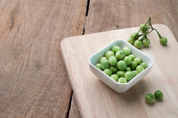 Green Small eggplant on the white plate,Asian food ingredients.