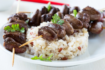 Skewered and grilled chicken hearts