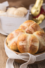 Homemade Easter hot cross buns in wooden bowl