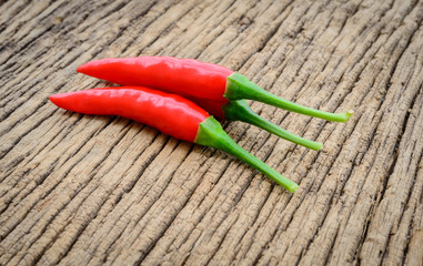 some chili peppers on a wood table