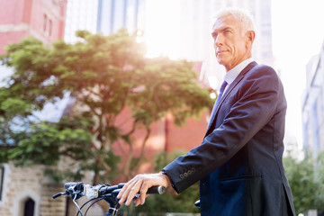 Fototapeta premium Successful businessman riding bicycle
