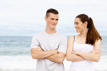 Fototapeta premium Young couple looking at each other on beach