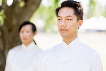 Handsome man practicing thai chi