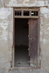 Traditional weathered wooden door frame, Old Ras Al Khaimah abandoned ghost town, Al Jazirah Al Hamra