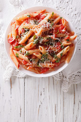 Arrabiata pasta penne with Parmesan cheese. vertical top view
