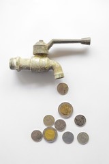 coin money flow out form steel faucet on white background