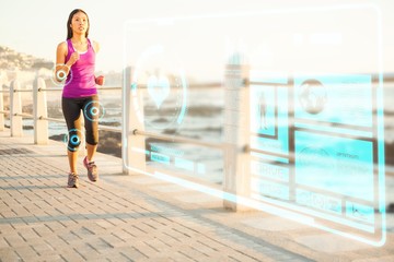 Composite image of fit woman jogging at promenade