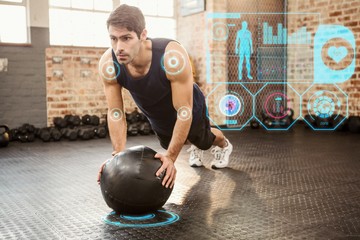Composite image of man doing push ups on medicine ball