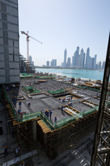 Fototapeta premium Viceroy Hotel development building site on the Palm, Dubai, with Dubai Marina skyline in the background
