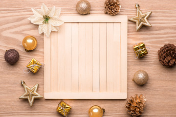 Beautiful christmas background: Collection of wooden Christmas objects isolated on fir branches on wooden background with copyspace. View from above