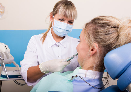 The reception was at the female dentist. Doctor examines the oral cavity on tooth decay.
