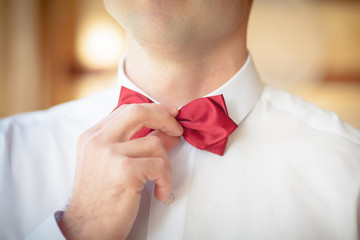 groom in a red bow tie