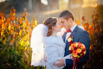 autumn wedding bride and groom on the street