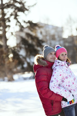 Fototapeta premium In winter, do not walk a guy hugs girl, looking in one direction