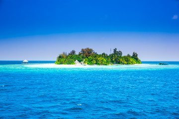 The solitary island and bungalows in the sea .