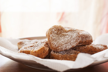 Freshly baked tasty heart shaped cookies on a plate