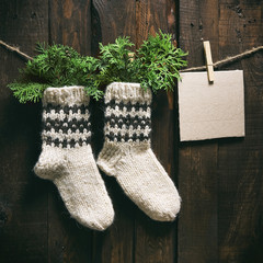 Hand knitted white wool santa socks christmas square postcard.