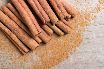  cinnamon sticks on wooden background
