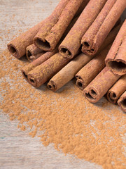  cinnamon sticks on wooden background