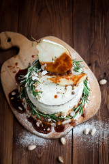 Cream pie with pear and decoration on table