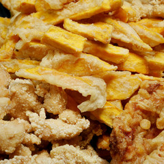 Taiwanese fried crispy sweet potato fries and deep fried popcorn chicken at food street night market.