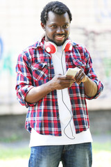 African American man with headphones outdoors