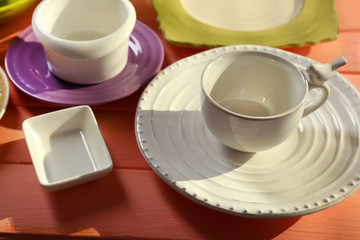 Different tableware on wooden table close up