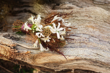 Wedding Bouquet lying on dry Tree Wood Background