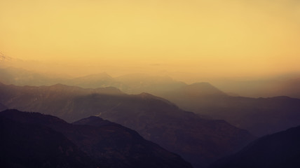 Naklejka na ściany i meble Himalayas mountain landscape. Mountains silhouettes at sunset in Nepal