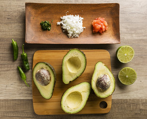 Ingredients for making guacamole on a wooden table