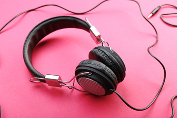 Black headphones on pink background