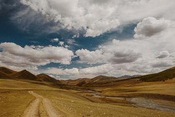 Way Road in mountains landscape with beautiful clouds