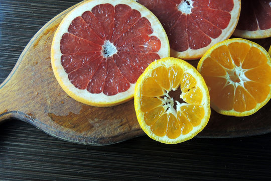 Grapefruit and Mandarin on a wooden Board