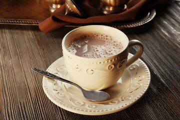 Vintage cup of cacao on wooden background