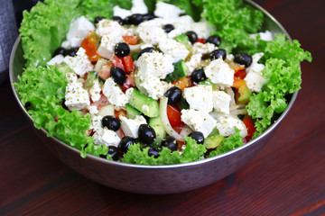 Greek salad in bowl on a table