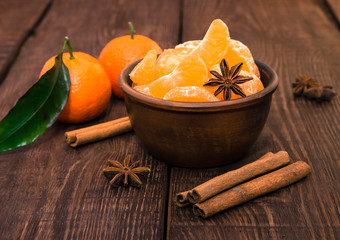 Tangerines with cinnamon stick and anisetree on old wooden table