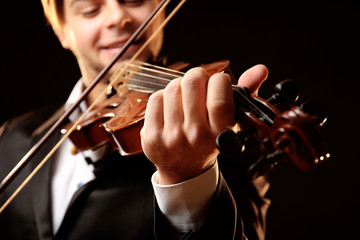 Musician plays violin on black background, close up © Africa Studio