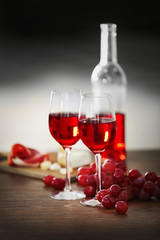 Two wineglasses with grape on the table