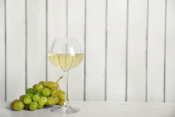 Wine and grape on wooden wall background