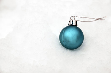 Christmas ball on snow background.