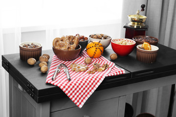 Served kitchen table with fruits, nuts and coffee, close up