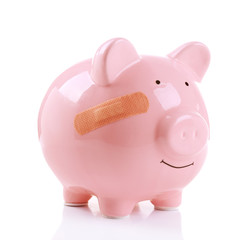 Piggy Bank with adhesive bandage, isolated on white