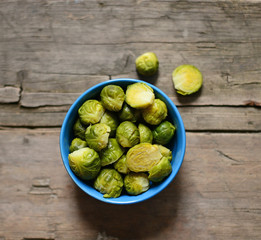 Fresh Brussels sprouts on wooden background