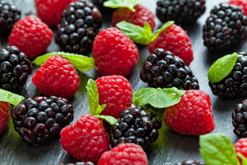 Heap of raspberry and blackberry on stone