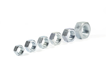 Metal Nuts Lined Up From Smallest To Largest Isolated On White 